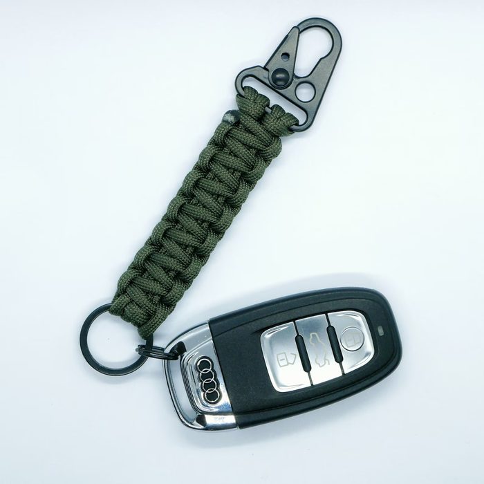Olive paracord car key lanyard attached to an Audi key fob